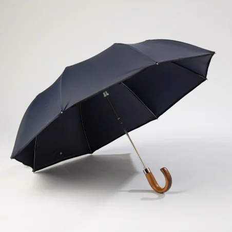 Navy blue folding umbrella, open from the front