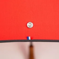 Umbrella with red handle and black trim, detail