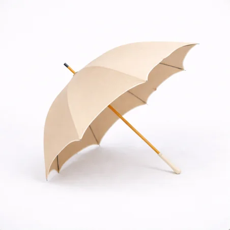 Chic champagne-colored UV-protective parasol with a beige bias-cut design, side view