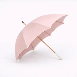 Chic pink UV-protective parasol with beige trim, open