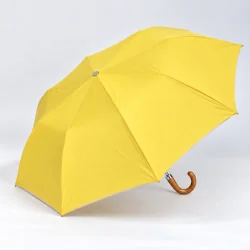 yellow folding umbrella opened on the side